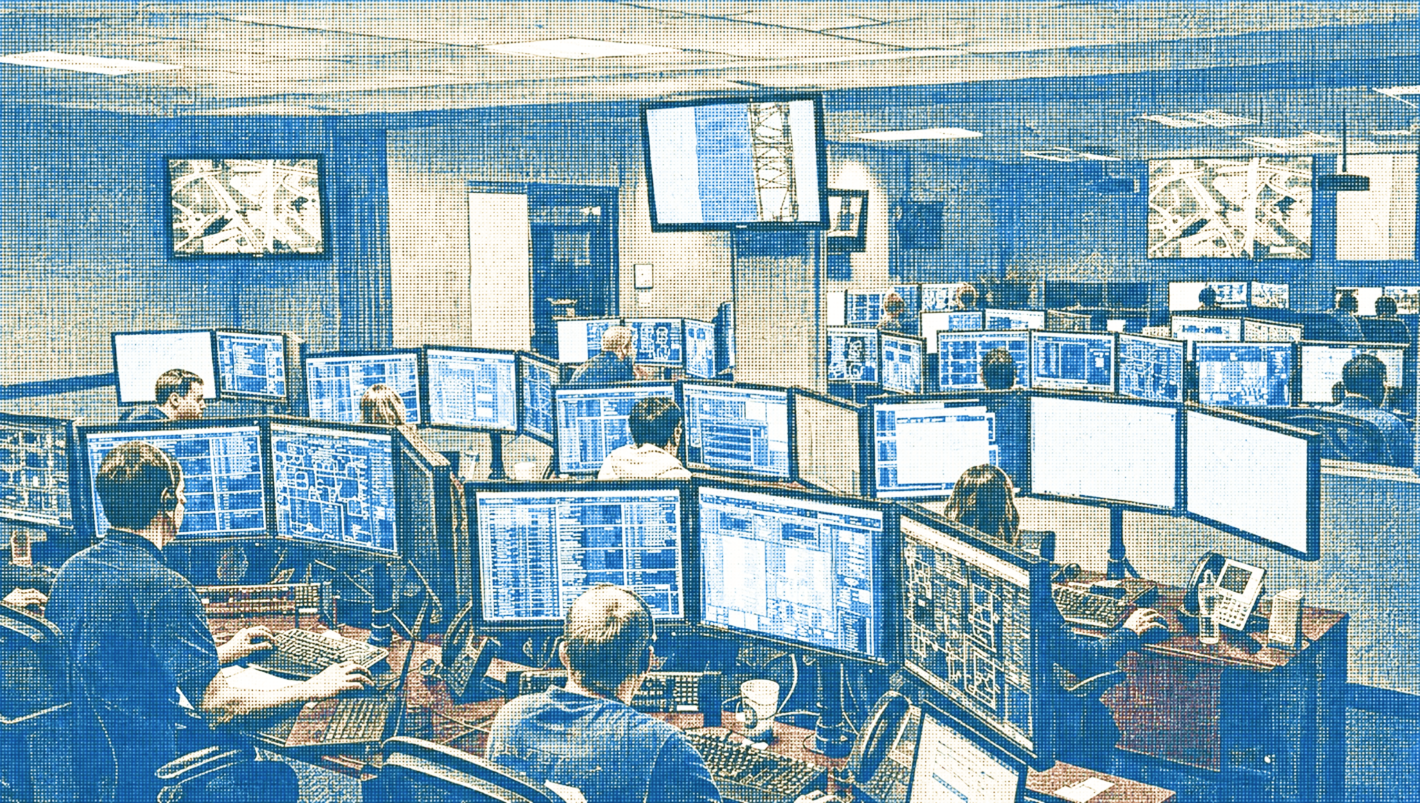 An operations floor: a team at work across dozens of screens